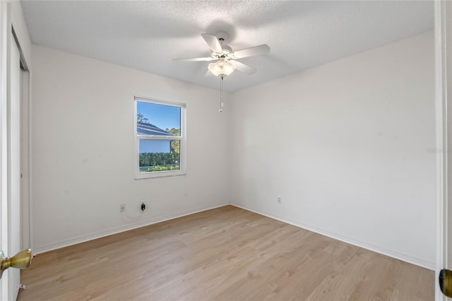 unfurnished bedroom featuring ceiling fan, a textured ceiling, and light hardwood / wood-style flooring