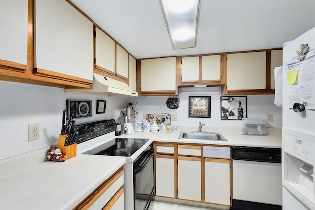 kitchen featuring white appliances, white cabinetry, and sink