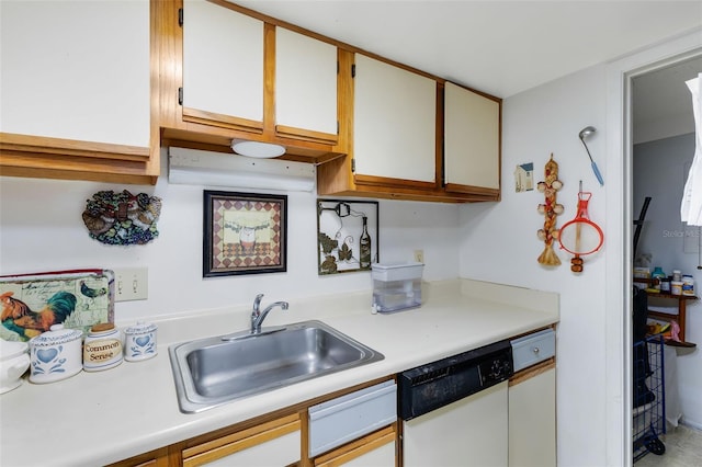 kitchen with white cabinets, white dishwasher, and sink