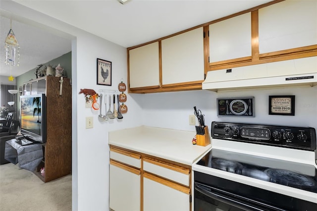 kitchen featuring light carpet, white electric stove, and white cabinetry