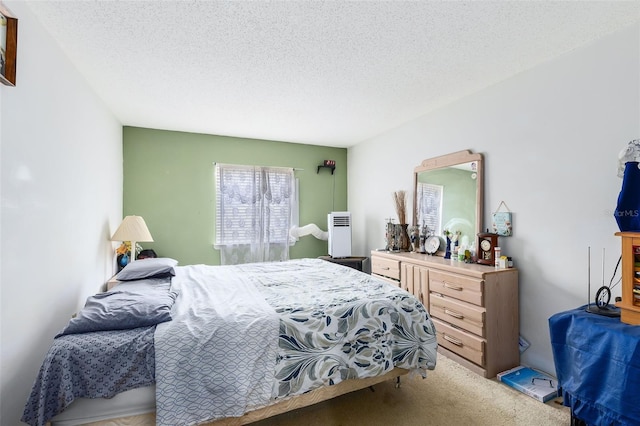 carpeted bedroom with a textured ceiling