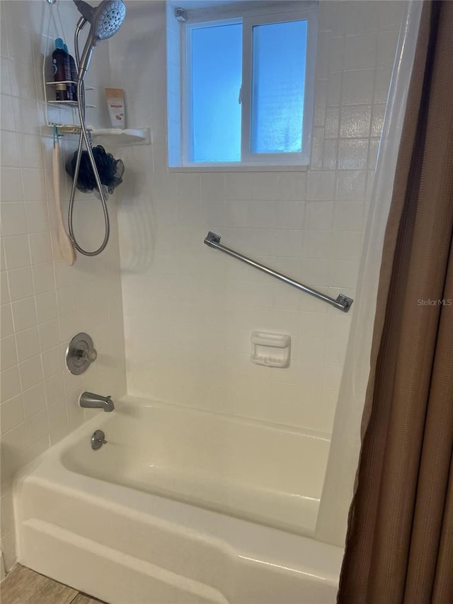 bathroom featuring shower / bath combo with shower curtain and hardwood / wood-style flooring