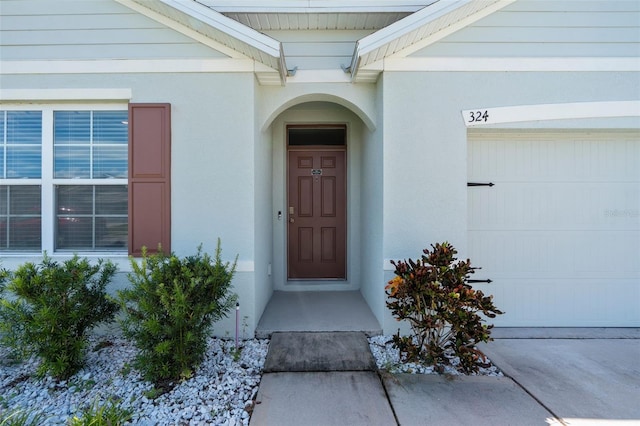 view of exterior entry featuring a garage