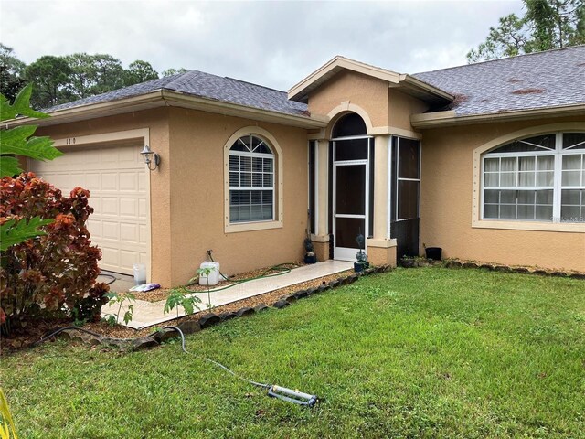 view of front of property with a front lawn and a garage