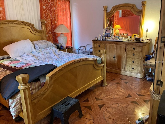 bedroom with dark parquet flooring