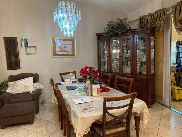 dining room featuring light tile patterned floors and a notable chandelier