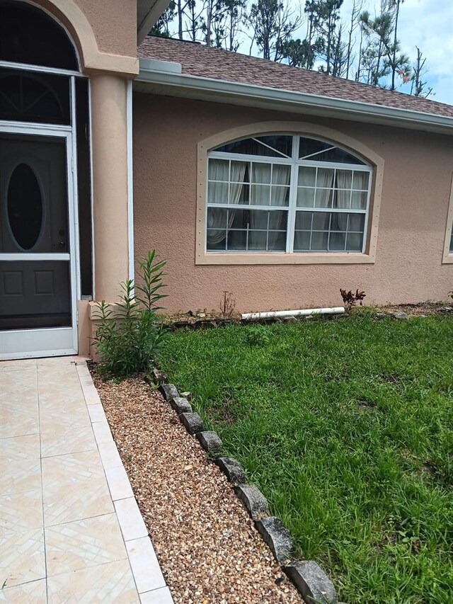 entrance to property with a yard