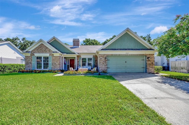 view of front of property with brick siding, a front lawn, concrete driveway, a chimney, and an attached garage