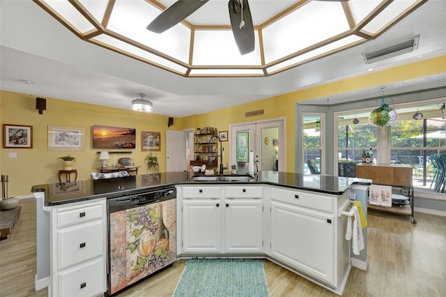 kitchen featuring dishwashing machine, visible vents, a sink, french doors, and dark countertops