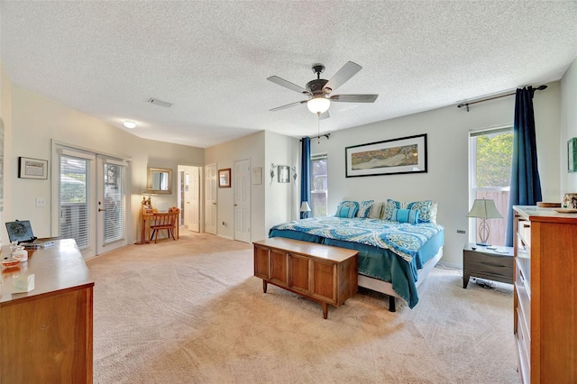 carpeted bedroom featuring a textured ceiling, ceiling fan, and access to outside