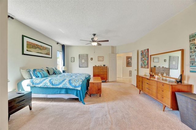 bedroom with light carpet, a textured ceiling, and a ceiling fan