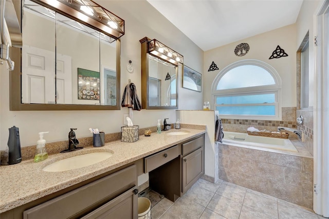 bathroom featuring tile patterned floors, tiled bath, and vanity