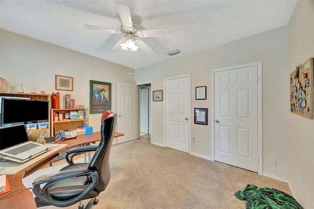 office with ceiling fan, light colored carpet, and a textured ceiling