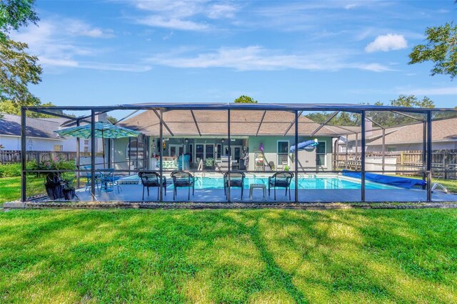 view of swimming pool featuring a lawn and a patio