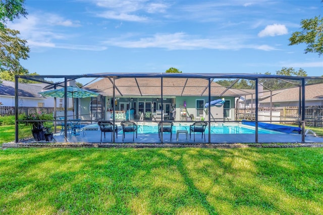 view of swimming pool featuring glass enclosure, a fenced in pool, fence, and a lawn