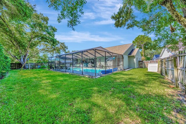 view of yard featuring a lanai and a fenced in pool