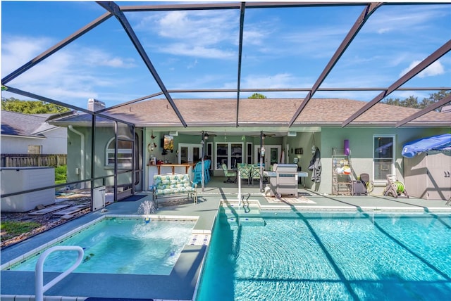 view of swimming pool featuring ceiling fan, a lanai, and a patio