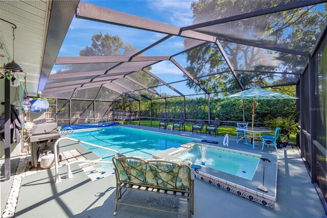 view of pool featuring a lanai, an in ground hot tub, and a patio