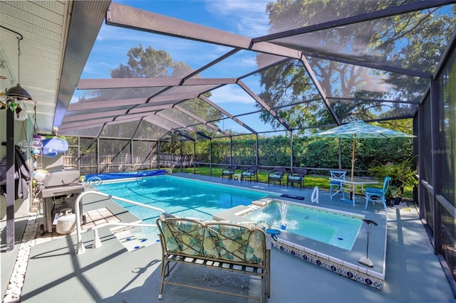 view of pool featuring grilling area, glass enclosure, a pool with connected hot tub, and a patio