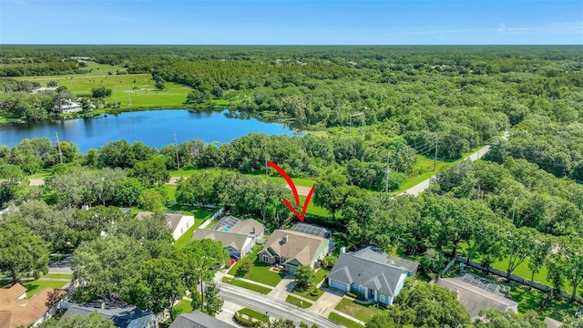 aerial view with a residential view, a view of trees, and a water view