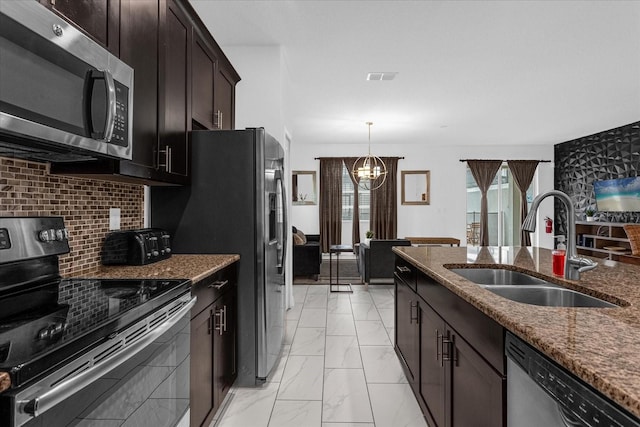 kitchen with backsplash, stainless steel appliances, dark brown cabinets, sink, and light tile patterned floors