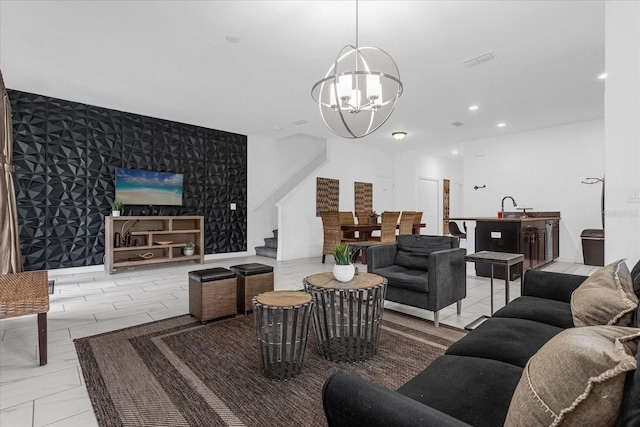 living room with sink, light tile patterned flooring, and an inviting chandelier