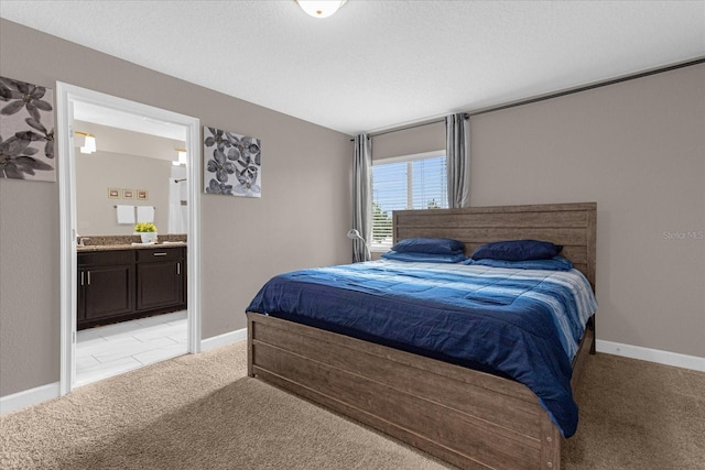 bedroom featuring light colored carpet and ensuite bathroom