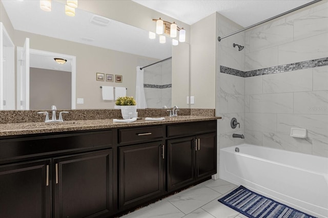 bathroom with tiled shower / bath, tile patterned floors, and vanity