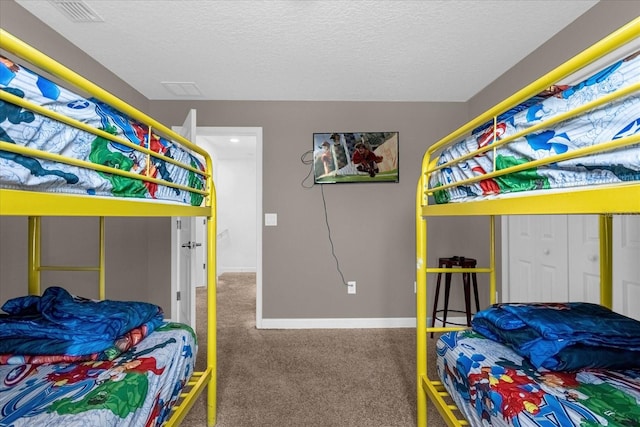 carpeted bedroom with a textured ceiling