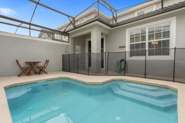 view of swimming pool with glass enclosure