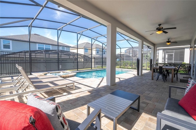 view of swimming pool with glass enclosure, ceiling fan, and a patio