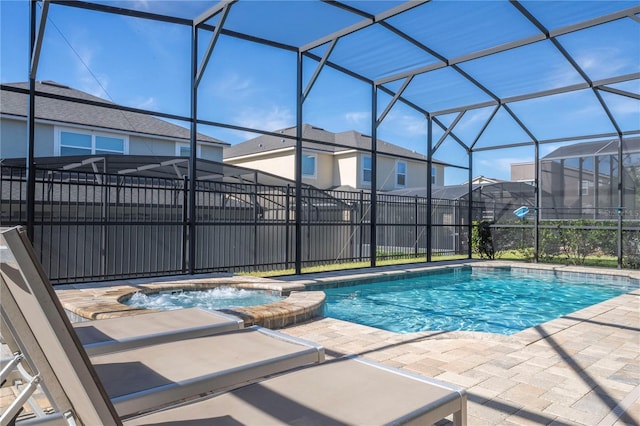 view of pool featuring a lanai, an in ground hot tub, and a patio