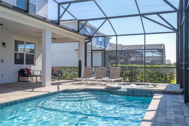 view of swimming pool featuring a lanai, a patio area, and ceiling fan