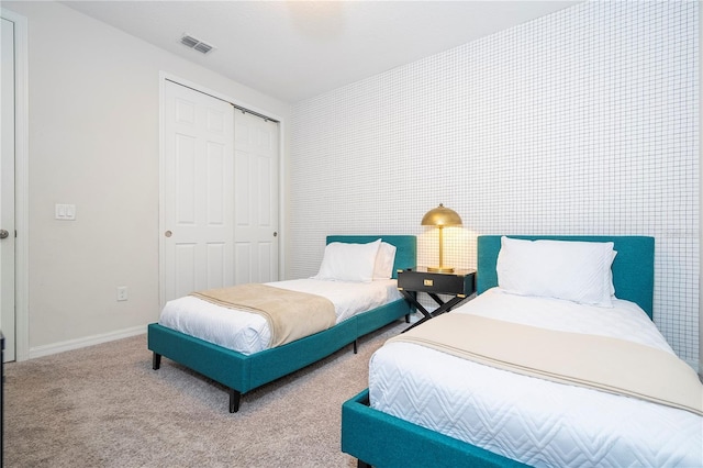 carpeted bedroom with a closet