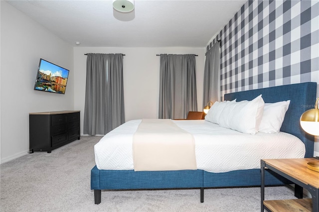 bedroom with light carpet and a textured ceiling