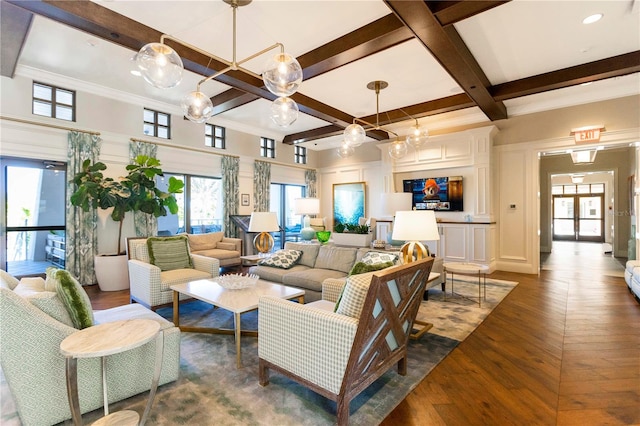 living room featuring coffered ceiling, a healthy amount of sunlight, hardwood / wood-style floors, and beamed ceiling