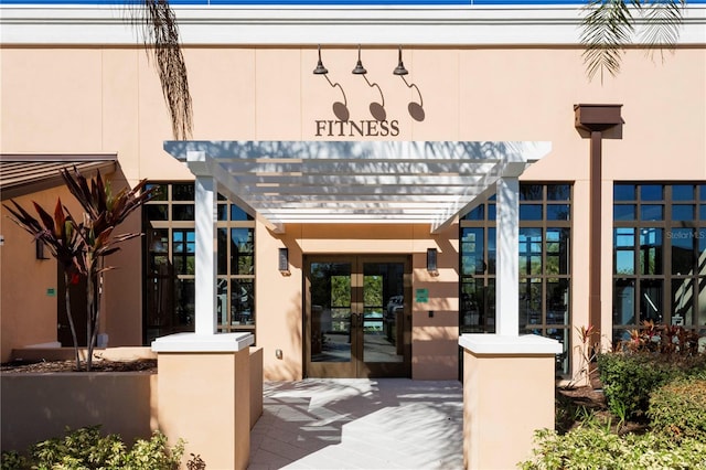 view of exterior entry featuring french doors