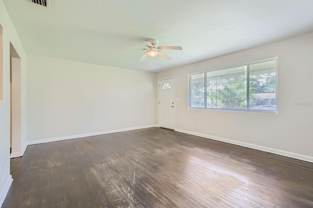 spare room with ceiling fan and dark hardwood / wood-style floors