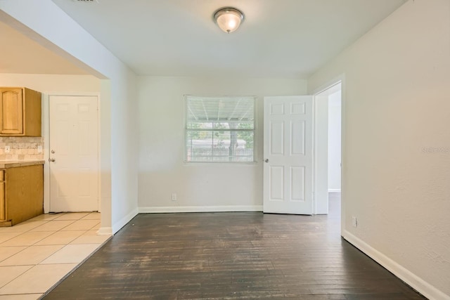 spare room featuring wood-type flooring