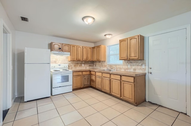 kitchen with sink, backsplash, white appliances, and light tile patterned floors