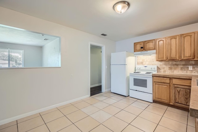 kitchen with decorative backsplash, white appliances, and light tile patterned floors