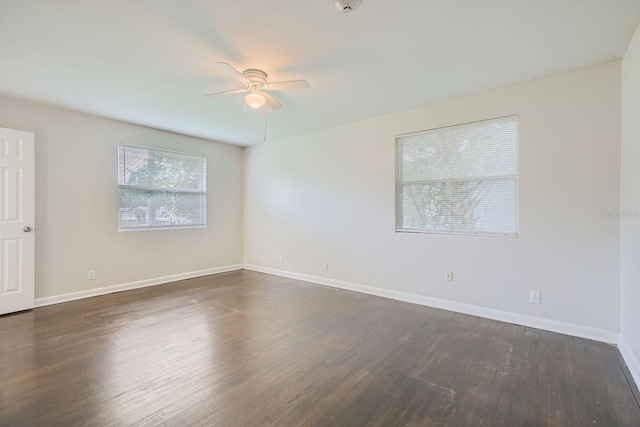 spare room with ceiling fan and dark hardwood / wood-style floors