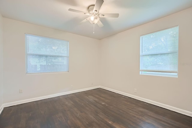 unfurnished room with dark wood-style floors, ceiling fan, and baseboards