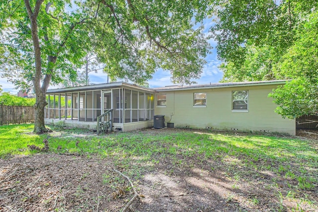 rear view of property featuring cooling unit and a sunroom