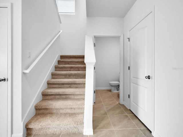 staircase with light tile patterned flooring