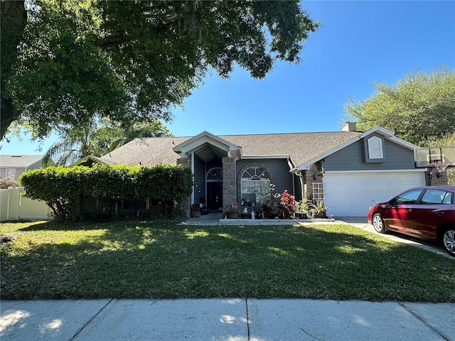 view of front of home with a front yard and a garage