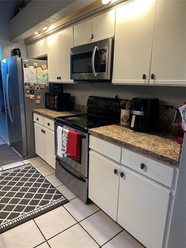 kitchen featuring white cabinetry, light tile patterned floors, and appliances with stainless steel finishes