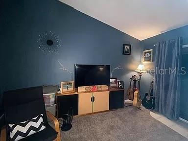 bedroom featuring carpet and vaulted ceiling