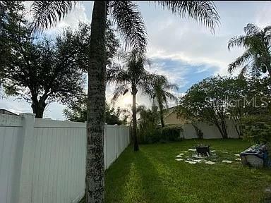 view of yard featuring a fenced backyard and an outdoor fire pit