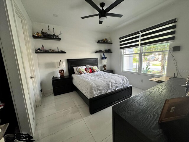 tiled bedroom featuring ceiling fan